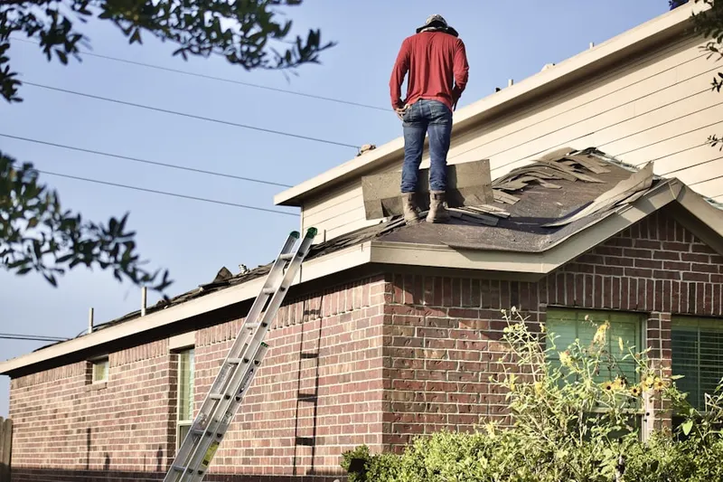 Professional roofer working on a residential roof in Hi-Nella